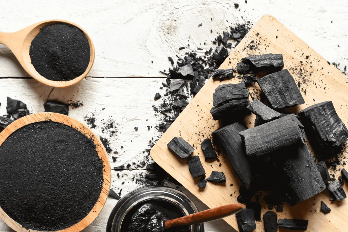 Activated carbon powder and charcoal pieces used in a carbon laser facial