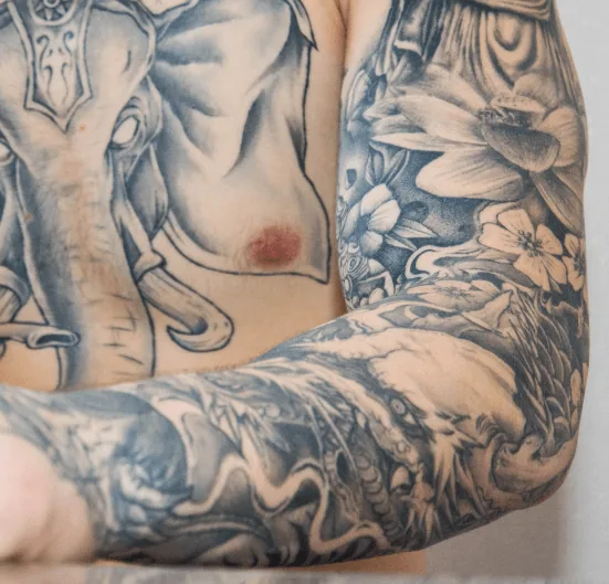 Full black-and-grey arm sleeve tattoo